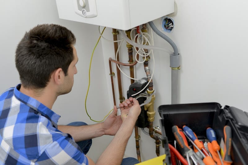 plumber servicing a gas boiler